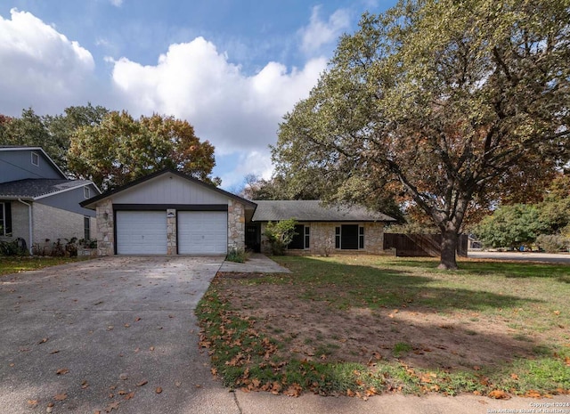 single story home with a front yard and a garage