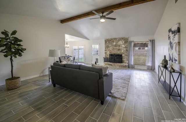 living room with beamed ceiling, high vaulted ceiling, dark hardwood / wood-style floors, a fireplace, and ceiling fan with notable chandelier