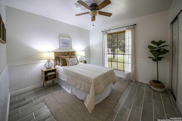 bedroom featuring ceiling fan, a closet, and dark wood-type flooring