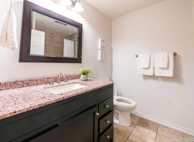 bathroom with tile patterned flooring, vanity, toilet, and a shower with curtain