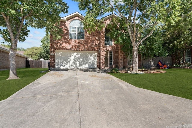 view of property featuring a front lawn and a garage