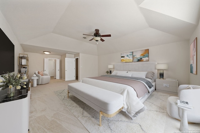 bedroom with light colored carpet, ceiling fan, and lofted ceiling