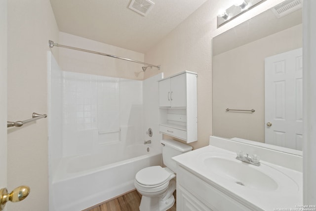 full bathroom featuring tub / shower combination, a textured ceiling, toilet, vanity, and hardwood / wood-style flooring