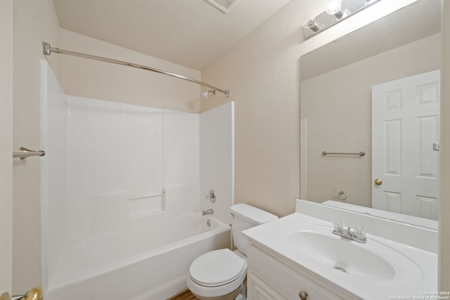 full bathroom with a textured ceiling, vanity, toilet, and tub / shower combination