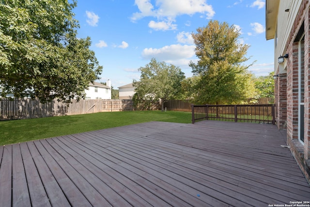 wooden deck featuring a yard