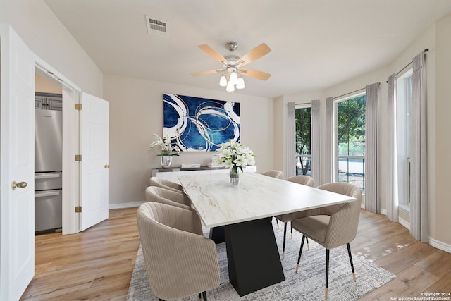 dining area featuring ceiling fan and light wood-type flooring