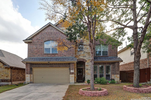 view of property featuring a garage and a front yard