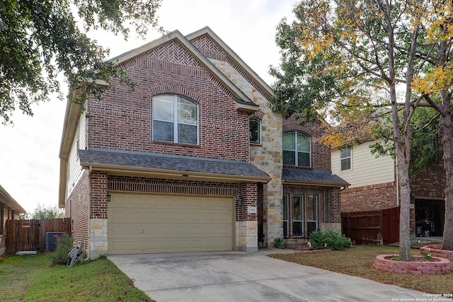 view of front of house featuring central AC unit, a garage, and a front yard