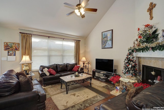 living room featuring hardwood / wood-style flooring, ceiling fan, a fireplace, and high vaulted ceiling