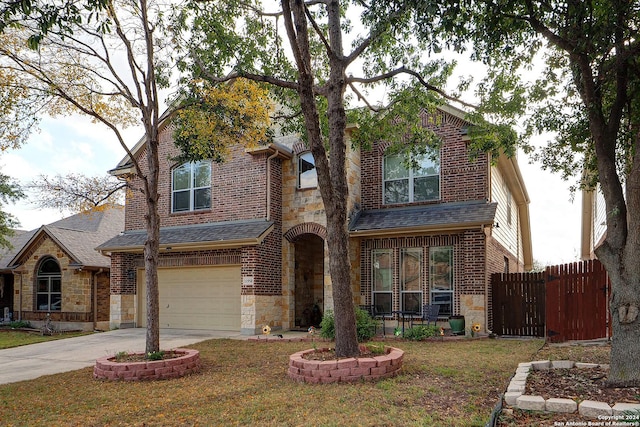 view of front of house with a front yard and a garage