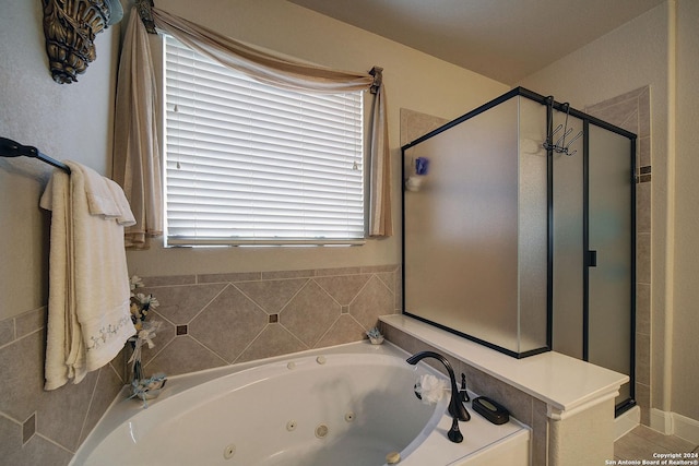 bathroom featuring shower with separate bathtub