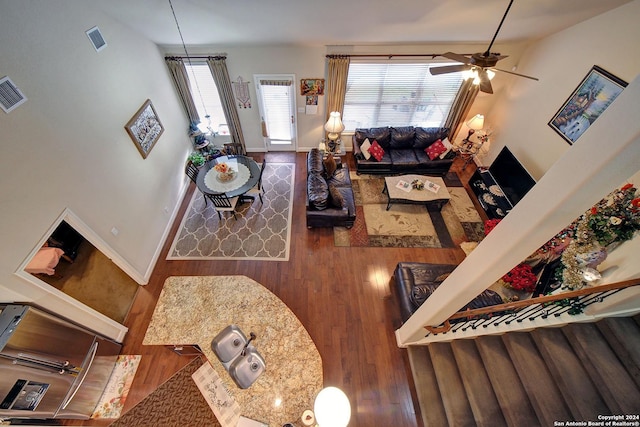 living room featuring ceiling fan and hardwood / wood-style flooring