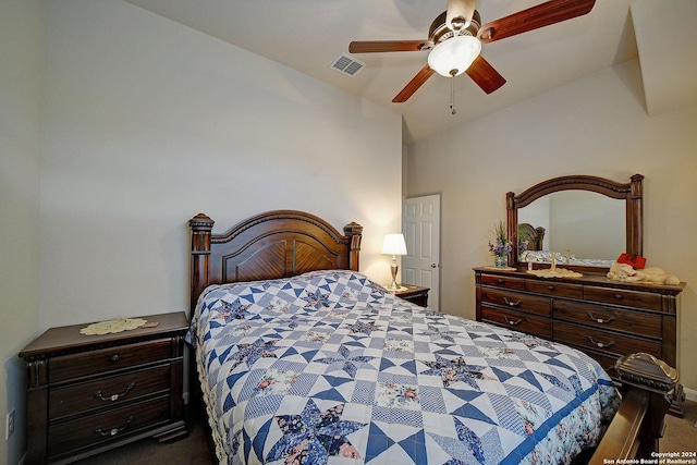 bedroom with dark colored carpet, vaulted ceiling, and ceiling fan