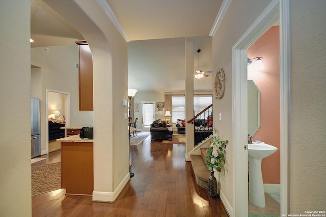 hall with crown molding and dark wood-type flooring