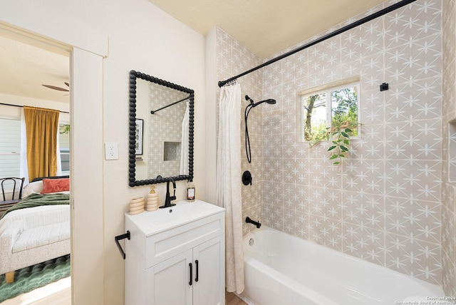 ensuite bathroom with shower / tub combo, vanity, and ensuite bathroom