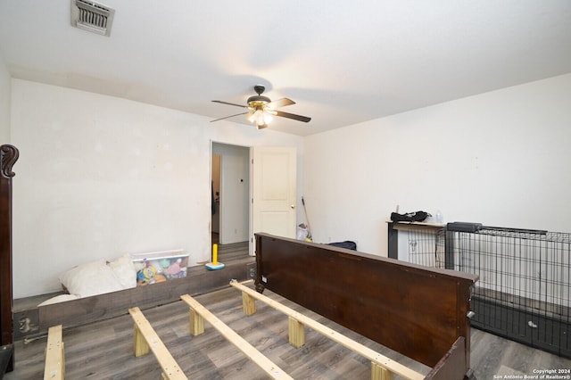 bedroom with ceiling fan and dark hardwood / wood-style flooring