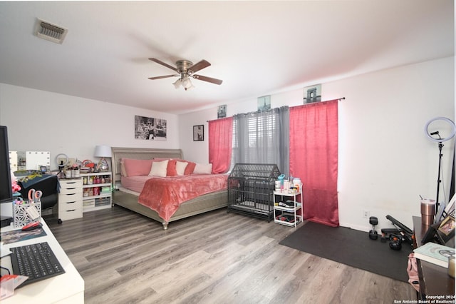 bedroom with ceiling fan and hardwood / wood-style floors