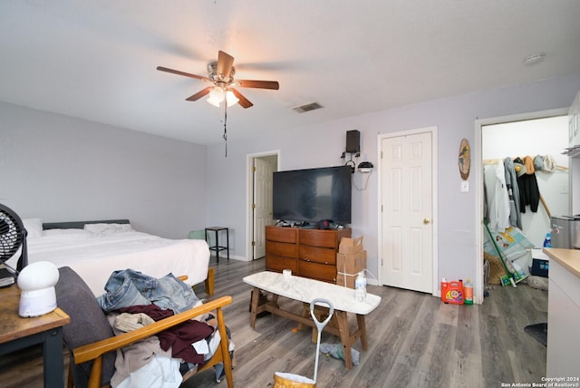 bedroom with dark hardwood / wood-style flooring and ceiling fan