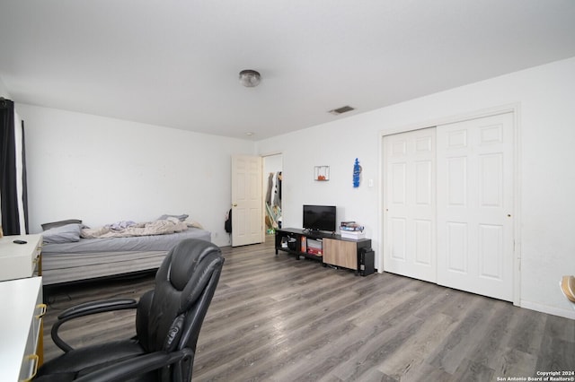 bedroom with wood-type flooring and a closet