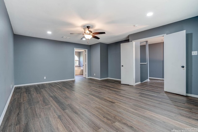 empty room with ceiling fan and dark hardwood / wood-style flooring