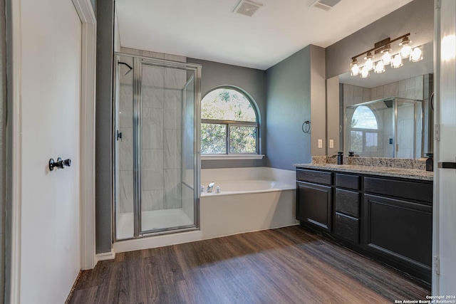 bathroom with shower with separate bathtub, vanity, and hardwood / wood-style flooring