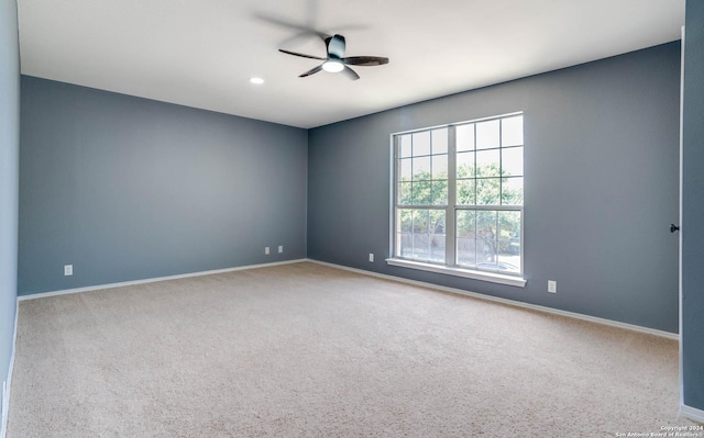 empty room with light colored carpet and ceiling fan