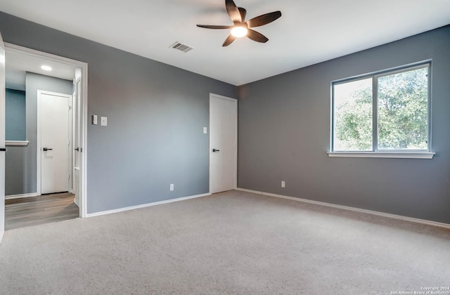 carpeted empty room with ceiling fan