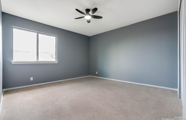 spare room featuring carpet flooring and ceiling fan