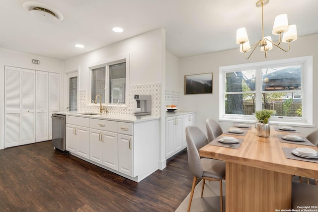 kitchen with dark hardwood / wood-style flooring, tasteful backsplash, sink, decorative light fixtures, and white cabinetry