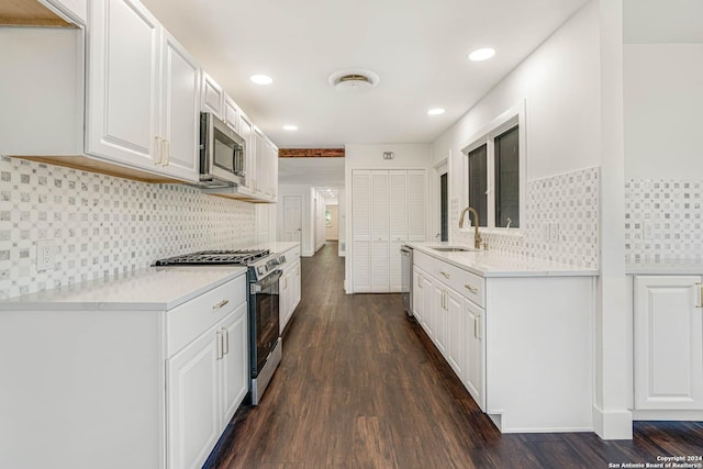 kitchen featuring dark hardwood / wood-style floors, sink, decorative backsplash, and stainless steel appliances