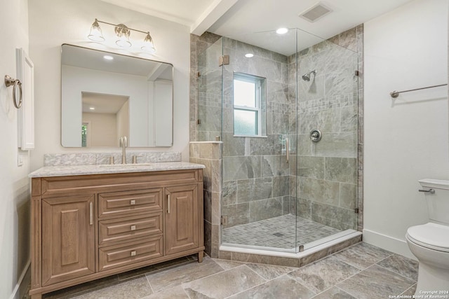 bathroom with vanity, toilet, and walk in shower