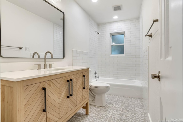 full bathroom featuring vanity, toilet, and tiled shower / bath