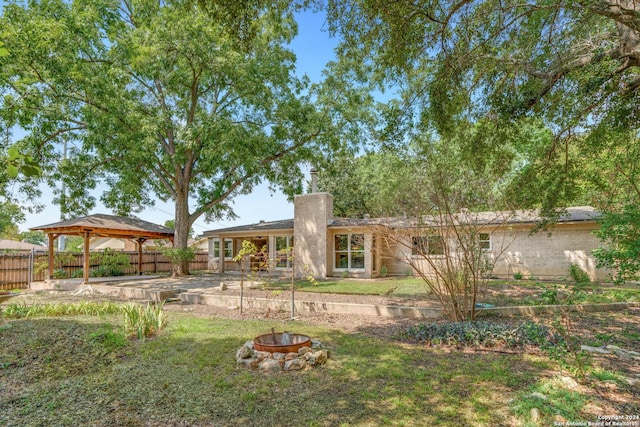 view of yard with a gazebo and an outdoor fire pit