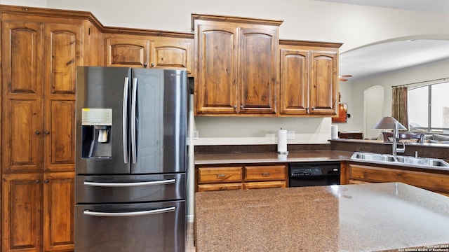 kitchen with stainless steel fridge, sink, and black dishwasher