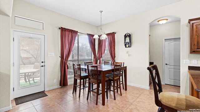 dining area featuring a notable chandelier and light tile patterned floors