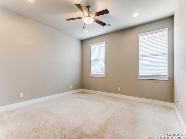 carpeted empty room featuring ceiling fan