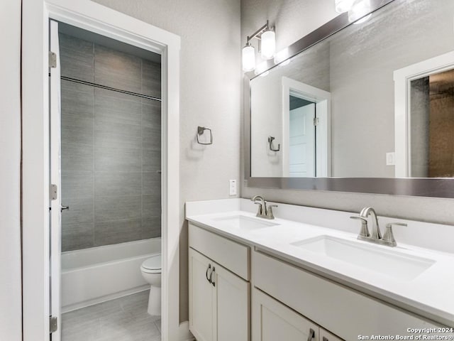 full bathroom with toilet, tiled shower / bath combo, and vanity