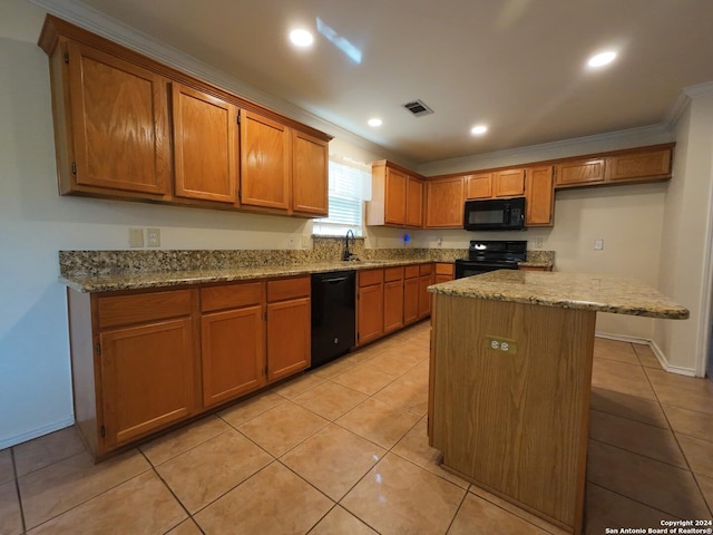 kitchen featuring a center island, sink, light stone counters, light tile patterned floors, and black appliances