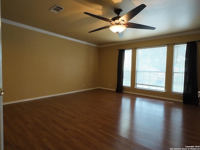 spare room with ceiling fan, plenty of natural light, dark hardwood / wood-style floors, and ornamental molding