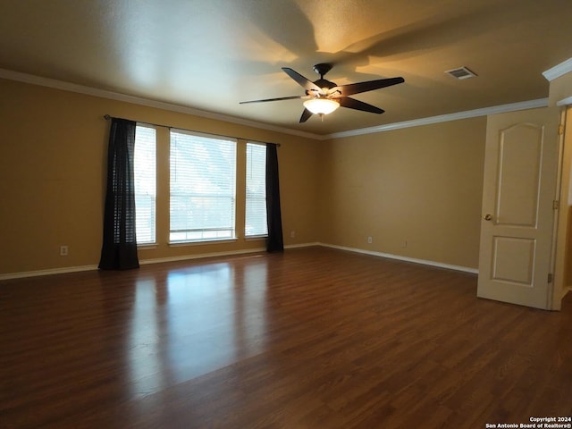 empty room featuring ceiling fan, crown molding, and dark wood-type flooring