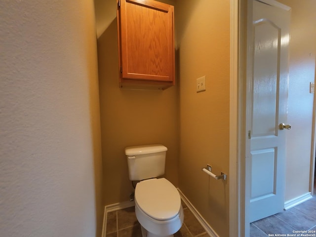 bathroom featuring tile patterned flooring and toilet