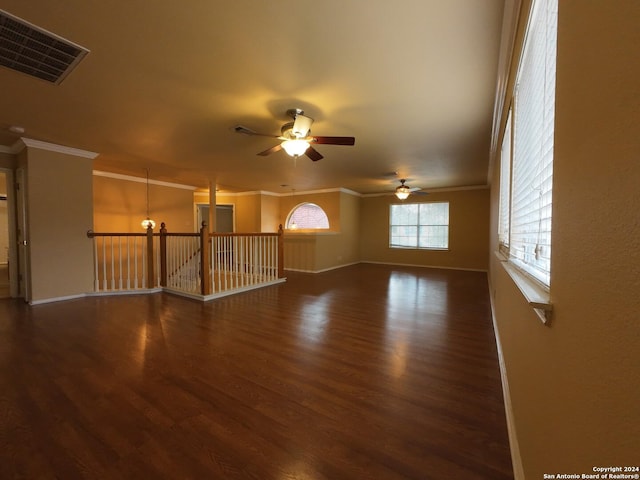 spare room featuring ceiling fan with notable chandelier, ornamental molding, and dark wood-type flooring