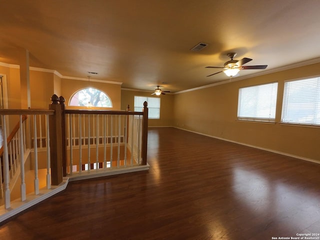 unfurnished room featuring dark wood-type flooring, ceiling fan, and ornamental molding