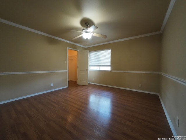 unfurnished room featuring ceiling fan, crown molding, and dark wood-type flooring