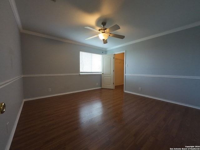 unfurnished room featuring ceiling fan, dark hardwood / wood-style flooring, and ornamental molding