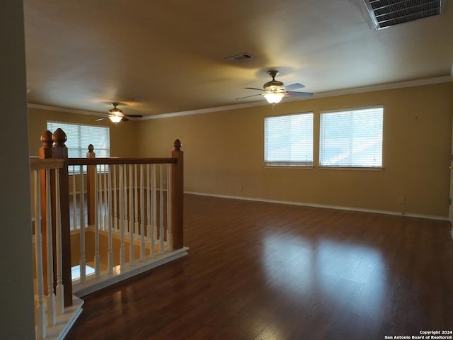 spare room featuring dark hardwood / wood-style flooring and ornamental molding