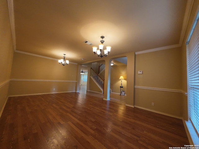 unfurnished living room featuring a chandelier, dark hardwood / wood-style floors, and crown molding