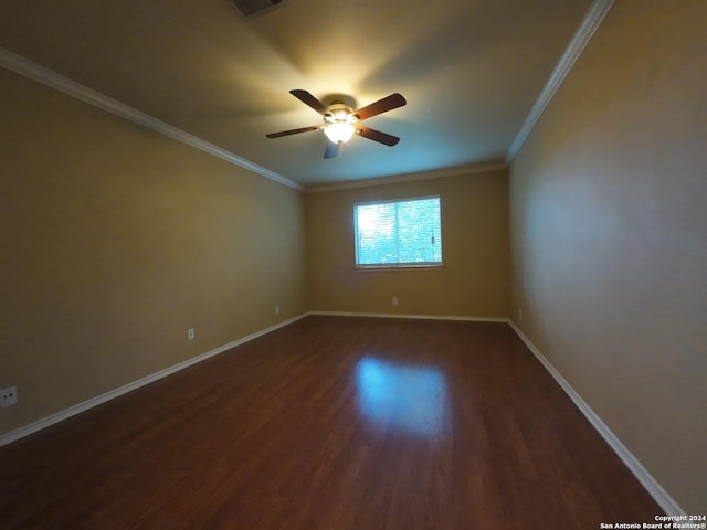 spare room featuring dark hardwood / wood-style floors, ceiling fan, and ornamental molding