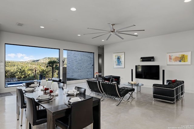 dining space with a mountain view, ceiling fan, and a healthy amount of sunlight