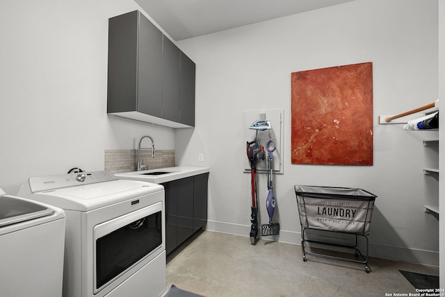 clothes washing area featuring cabinets, separate washer and dryer, and sink